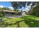 The green, grassy backyard features a basketball hoop and ample space at 3220 Cardigan Ct, Orlando, FL 32812