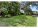 Spacious backyard featuring lush green grass, mature trees, and ample space for outdoor activities at 3220 Cardigan Ct, Orlando, FL 32812