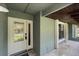 Inviting front porch with neutral tile and a stylish front door and window at 3220 Cardigan Ct, Orlando, FL 32812