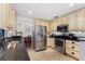 Well-equipped kitchen boasts stainless steel appliances, granite countertops, and custom cabinetry at 3220 Cardigan Ct, Orlando, FL 32812