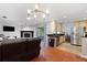 Open-concept living and kitchen area with fireplace and stainless steel appliances at 3220 Cardigan Ct, Orlando, FL 32812