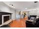 Cozy living room with hardwood floors, fireplace, and an open layout to the kitchen at 3220 Cardigan Ct, Orlando, FL 32812