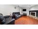 Bright living room featuring hardwood floors, leather sofas, and a modern fireplace at 3220 Cardigan Ct, Orlando, FL 32812