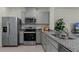 Well-lit kitchen features stainless steel appliances, grey cabinets, and granite countertops at 3304 Wye Oak Dr, Apopka, FL 32703