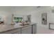 Kitchen island featuring granite countertops with stainless steel dishwasher and sink at 3304 Wye Oak Dr, Apopka, FL 32703