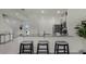 Modern kitchen with barstool seating, gray cabinets, and stainless steel appliances at 3304 Wye Oak Dr, Apopka, FL 32703