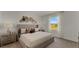 Comfortable main bedroom features plush carpet, king bed, and view from the window at 3304 Wye Oak Dr, Apopka, FL 32703