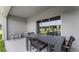 Covered patio with outdoor dining set, perfect for enjoying the scenic views and outdoor living at 3310 Wye Oak Dr, Apopka, FL 32703