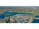 Breathtaking aerial view showcasing a community's pool, tennis courts, and lakefront property surrounded by lush greenery at 387 Devon Pl, Lake Mary, FL 32746