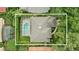 Aerial view of the home with a screened pool, landscaping, and surrounding greenery at 387 Devon Pl, Lake Mary, FL 32746
