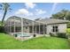 Relaxing screened-in pool area with lush green grass, providing a private outdoor oasis at 387 Devon Pl, Lake Mary, FL 32746