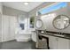 Primary bathroom featuring a soaking tub, dual sinks, dark countertops and tile floors at 387 Devon Pl, Lake Mary, FL 32746