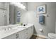 Bathroom featuring dual sinks, tile floors, decorative art, towel rack and modern fixtures at 387 Devon Pl, Lake Mary, FL 32746