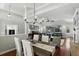 Dining room with hardwood floors, chandelier, and views of the living room and backyard pool at 387 Devon Pl, Lake Mary, FL 32746