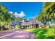 Stone gate with meticulous landscaping at community entrance at 387 Devon Pl, Lake Mary, FL 32746