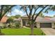 Charming single-story home featuring lush landscaping, a two-car garage, and a meticulously maintained front yard at 387 Devon Pl, Lake Mary, FL 32746