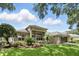 Stunning one-story home featuring manicured landscaping, a tile roof and an attached two-car garage at 387 Devon Pl, Lake Mary, FL 32746