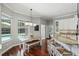 Eat-in kitchen with white cabinets, granite countertops, and views of the backyard pool at 387 Devon Pl, Lake Mary, FL 32746