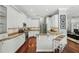 Modern kitchen with white cabinets, granite countertops, and counter seating at 387 Devon Pl, Lake Mary, FL 32746