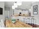 Eat-in kitchen with white cabinets, granite countertops and modern pendant lighting at 387 Devon Pl, Lake Mary, FL 32746