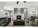 Bright living room with fireplace, built-ins and dark wood flooring at 387 Devon Pl, Lake Mary, FL 32746