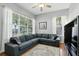 Comfortable living room with large windows, hardwood floors, ceiling fan and large sofa at 387 Devon Pl, Lake Mary, FL 32746