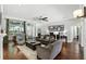 Comfortable living room featuring a wall of photos, hardwood floors and neutral paint at 387 Devon Pl, Lake Mary, FL 32746
