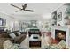 Cozy living room with fireplace, neutral decor, and view of the backyard pool and dining area at 387 Devon Pl, Lake Mary, FL 32746
