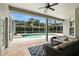Inviting covered patio with comfortable seating area and a view of the screened-in pool and spa at 387 Devon Pl, Lake Mary, FL 32746