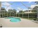 Screened pool with jacuzzi, surrounded by a large deck, hedges and landscaping at 387 Devon Pl, Lake Mary, FL 32746