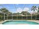 Backyard screened pool with spa and clear blue water at 387 Devon Pl, Lake Mary, FL 32746