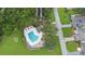 Aerial view of neighborhood pool surrounded by lush trees at 42 W Grenewood Ln, Haines City, FL 33844