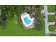 Aerial shot of a neighborhood pool with seating and lush landscaping at 42 W Grenewood Ln, Haines City, FL 33844
