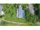 Aerial view of a home with mature trees and manicured landscaping at 42 W Grenewood Ln, Haines City, FL 33844