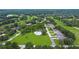 Aerial view of neighborhood with a community pool, landscaping, and several homes at 42 W Grenewood Ln, Haines City, FL 33844