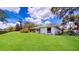 Lush backyard featuring a well-manicured lawn and mature trees at 42 W Grenewood Ln, Haines City, FL 33844