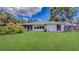 Expansive backyard featuring a large grassy lawn and colorful plants at 42 W Grenewood Ln, Haines City, FL 33844