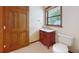 Charming bathroom with custom vanity, marble sink, and decorative faucet and a wooden door at 42 W Grenewood Ln, Haines City, FL 33844