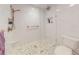 Modern bathroom showcasing a glass shower with gold hardware and marbled tile at 42 W Grenewood Ln, Haines City, FL 33844