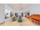 Bright, open-concept living room with tile flooring and large windows, showcasing a seamless flow and modern design at 42 W Grenewood Ln, Haines City, FL 33844