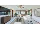 Cozy seating area with tile floors, a ceiling fan, and bright windows offering a relaxing view of the outdoors at 42 W Grenewood Ln, Haines City, FL 33844