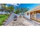 A backyard patio with a barbeque grill, seating, and a concrete privacy wall at 42 W Grenewood Ln, Haines City, FL 33844