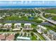 Aerial view of condo community, lush landscaping, boat docks, and ocean view at 426 Bouchelle Dr # 202, New Smyrna Beach, FL 32169