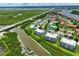 An aerial view showcasing waterfront condos nestled amidst lush greenery and serene waterways, near a bridge at 426 Bouchelle Dr # 202, New Smyrna Beach, FL 32169