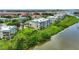 Aerial view of waterfront condo complex surrounded by lush landscaping and water views at 426 Bouchelle Dr # 202, New Smyrna Beach, FL 32169