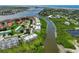 Aerial view of waterfront condo community with boat docks and lush surrounding landscape at 426 Bouchelle Dr # 202, New Smyrna Beach, FL 32169