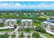 Beautiful aerial view of condo building, lake, and ocean in the distance on a sunny day at 426 Bouchelle Dr # 202, New Smyrna Beach, FL 32169