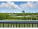 Enjoy this balcony view of the lush foliage and waterfront at 426 Bouchelle Dr # 202, New Smyrna Beach, FL 32169