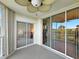 Balcony with sliding doors, ceiling fan, and view of the landscaped grounds at 426 Bouchelle Dr # 202, New Smyrna Beach, FL 32169