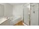 Bright bathroom featuring a shower with glass door and a soaking tub at 426 Bouchelle Dr # 202, New Smyrna Beach, FL 32169